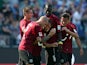 Hannover's Szabolcs Huszti is congratulated by team mates after scoring the opening goal against Schalke on August 24, 2013