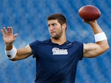 Tim Tebow #5 of the New England Patriots warms up prior to the game against the Tampa Bay Buccaneers at Gillette Stadium on August 16, 2013