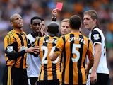 Hull's Yannick Sagbo is shown a straight red card by referee Mike Jones during the match against Norwich on August 24, 2013
