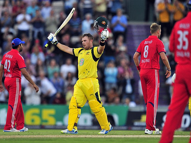 England players look on as Australia's Aaron Finch scores his century during their Twenty20 International cricket match on August 29, 2013