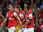 Arsenal's Aaron Ramsey is congratulated by team mates after scoring the opening goal against Fenerbahce during their Champions League play-off match on August 27, 2013