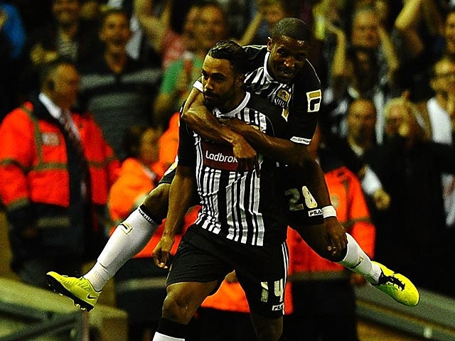 Notts County's Adam Coombes is congratulated by team mate Andre Boucaud after scoring the late equaliser against Liverpool during their League Cup match on August 27, 2013