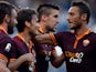 Roma's Adem Ljajic is congratulated by team mates after scoring his team's third goal against Hellas Verona on September 1, 2013