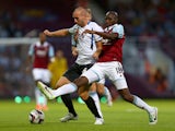 Russel Penn of Cheltenham Town battles with Alou Diarra of West Ham United during the Capital One Cup second round match between West Ham United and Cheltenham Town at The Boleyn Ground on August 27, 2013