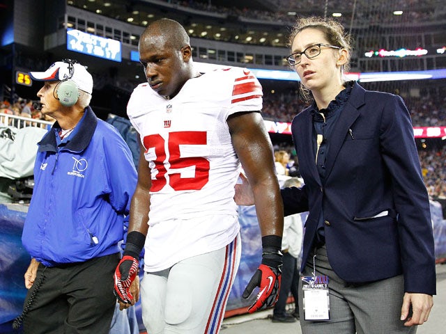 Andre Brown #35 of the New York Giants walks off of the field after breaking his leg against the New England Patriots during the preseason game at Gillette Stadium on August 29, 2013