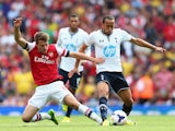 Aaron Ramsey of Arsenal tackles Andros Townsend of Spurs during the Barclays Premier League match between Arsenal and Tottenham Hotspur at Emirates Stadium on September 01, 2013