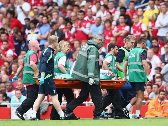 Etienne Capoue of Spurs is stretchered off during the Barclays Premier League match between Arsenal and Tottenham Hotspur at Emirates Stadium on September 01, 2013