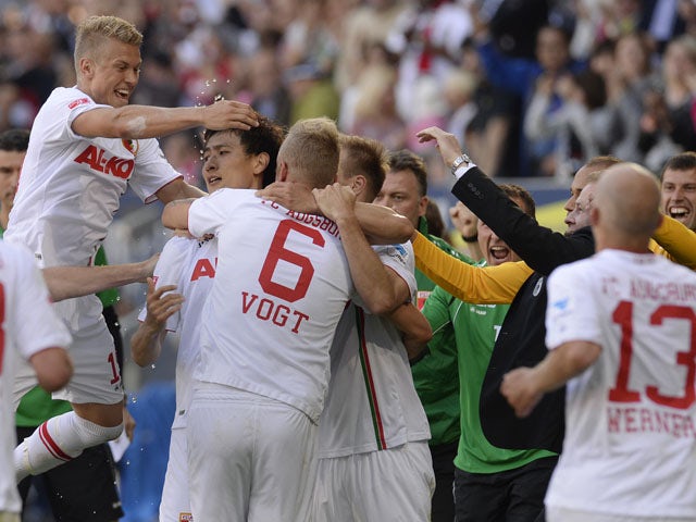 Augsburg's players celebrate after the third goal for Augsburg during the German first division Bundesliga match between FC Augsburg and Greuther Fuerth in Augsburg, southern Germany, on May 18, 2013