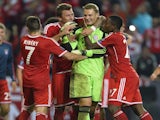 Bayern players congratulate Manuel Neuer after he saves Romelu Lukaku's penalty in the UEFA Super Cup final on August 30, 2013