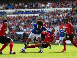 Ben Turner of Cardiff tackles Marouane Fellaini of Everton during the Barclays Premier League match between Cardiff City and Everton at Cardiff City Stadium on August 31, 2013
