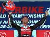 Carl Fogarty celebrates his victory in the first race of the Superbike world championships on the Kyalami racetrack outside Johannesburg on March 28, 1999