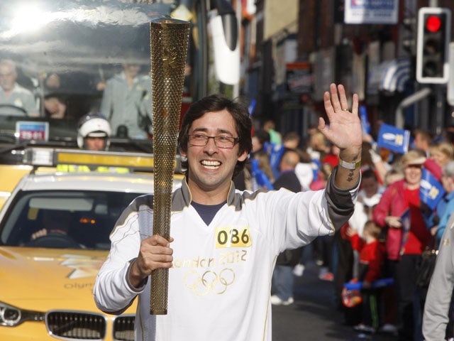  Murray carries the Olympic flame on day 19 of the London 2012 Olympic Torch Relay on June 6, 2012
