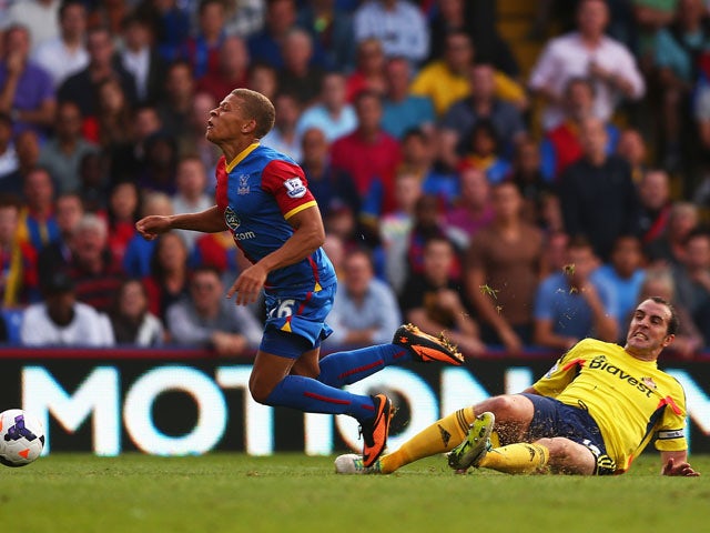 Dwight Gayle of Crystal Palace is brought down in the penalty area by John O'Shea of Sunderland leading to a penalty and his sending off during the Barclays Premier League match between Crystal Palace and Sunderland at Selhurst Park on August 31, 2013