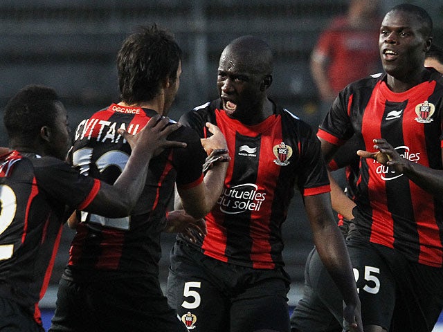 Nice's Dario Cvitanich is congratulated by team mates after scoring the opening goal against Apollon Limassol during their Europa League play-off match on August 29, 2013