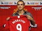Dimitar Berbatov holds up his shirt at his Manchester United unveiling.
