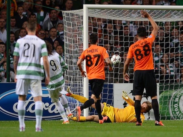 Celtic's Giorgos Samaras tucks the ball past the onrushing Shakhter Karagandy goalkeeper to put his side 2-0 up on August 28, 2013