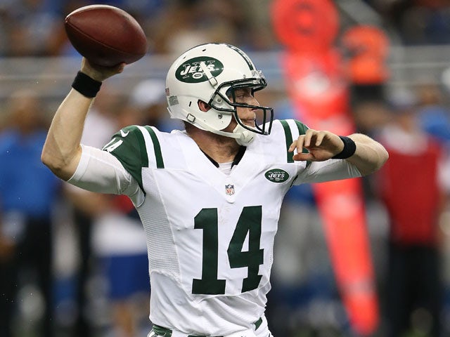 Greg McElroy #14 of the New York Jets rolls out to pass during the third quarter of the pre-season game against the Detroit Lions at Ford Field on August 9, 2013