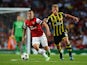Arsenal's Jack Wilshere and Fenerbahce's Dirk Kuyt battle for the ball during their Champions League play-off match on August 27, 2013