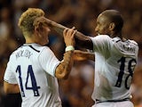 Spurs' Jermain Defoe is congratulated by team mate Lewis Holtby after scoring then opening goal against Dinamo Tbilisi during their Europa League play-off match on August 29, 2013