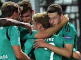 Schalke's Julian Draxler is congratulated by team mates after scoring his team's second goal against PAOK Thessaloniki during their Champions League play-off match on August 27, 2013