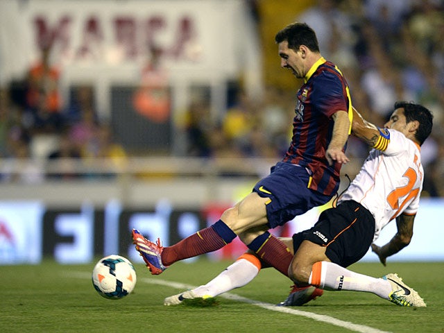 Barcelona's Lionel Messi scores the opening goal during the match against Valencia on September 1, 2013