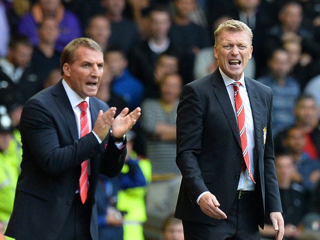 Manchester United's Scottish manager David Moyes reacts next to Liverpool's Northern Irish manager Brendan Rodgers during the English Premier League football match between Liverpool and Manchester United at the Anfield stadium in Liverpool, northwest Engl