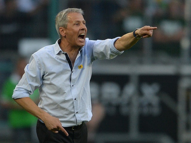Moenchengladbach coach Lucien Favre barks orders at his team during a game with Hannover on August 17, 2013
