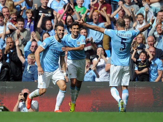 Alvaro Negredo of Manchester City celebrates with team-mates Jesus Navas and Pablo Zabaleta after scoring the opening goal of the Barclays Premier League match between Manchester City and Hull City at the Etihad Stadium on August 31, 2013