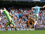 Alvaro Negredo of Manchester City scores the opening goal past Allan McGregor of Hull City during the Barclays Premier League match between Manchester City and Hull City at the Etihad Stadium on August 31, 2013