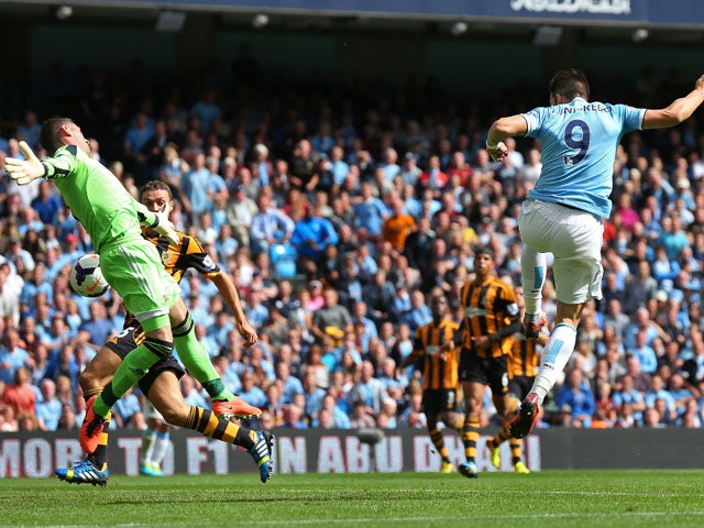 Alvaro Negredo of Manchester City scores the opening goal past Allan McGregor of Hull City during the Barclays Premier League match between Manchester City and Hull City at the Etihad Stadium on August 31, 2013