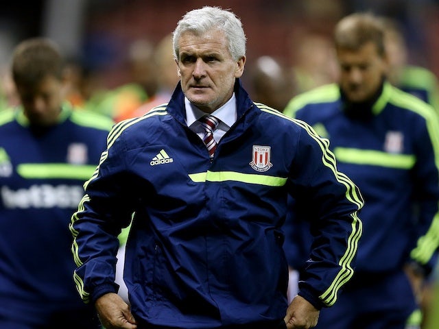 Stoke boss Mark Hughes walks to the dugout prior to their game with Walsall on August 28, 2013