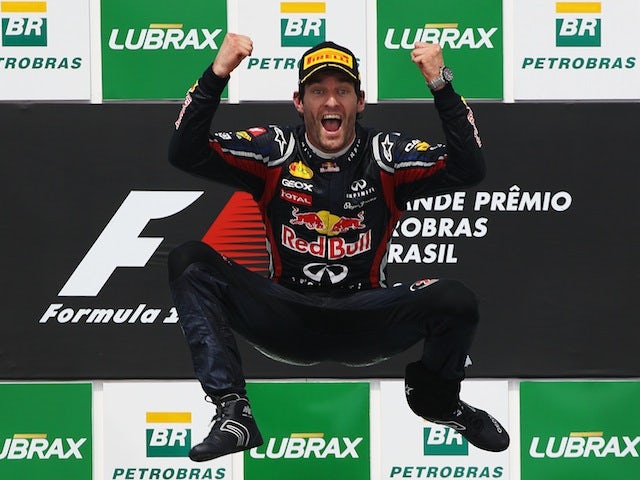 Red Bull driver Mark Webber jumps for joy on the podium after winning the Brazilian Grand Prix on November 27, 2011