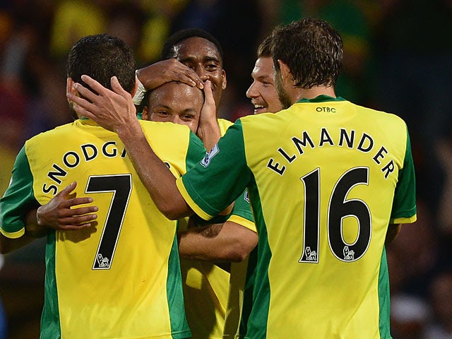 Norwich's Martin Olsson is congratulated by team mates after scoring the opening goal against Bury during their League Cup match on August 27, 2013