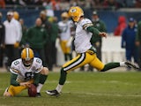 Mason Crosby #2 of the Green Bay Packers attempts a field goal out of the hold of Tim Masthay #8 at Soldier Field on December 16, 2012 