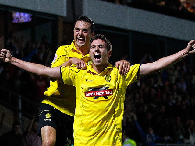 Burton's Michael Symes celebrates with team mate Jack Dyer after scoring his team's second goal against Fulham during their League Cup match on August 27, 2013