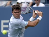 Milos Raonic eyes the ball against Thomas Fabbiano during the first round of the US Open on August 27, 2013