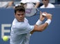 Milos Raonic eyes the ball against Thomas Fabbiano during the first round of the US Open on August 27, 2013