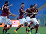 Roma's Miralem Pjanic is congratulated by team mates after scoring his team's second goal against Hellas Verona on September 1, 2013