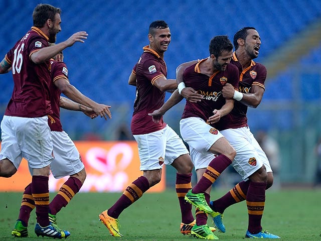 Roma's Miralem Pjanic is congratulated by team mates after scoring his team's second goal against Hellas Verona on September 1, 2013