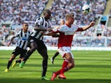 Mapou Yanga-Mbiwa of Newcastle United challenges for the ball with Alex Kacaniklic of Fulham during the Barclays Premier League match between Newcastle United and Fulham at St James' Park on August 31, 2013
