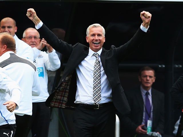 Newcastle United manager Alan Pardew celebrates as his side scores during the Barclays Premier League match between Newcastle United and Fulham at St James' Park on August 31, 2013
