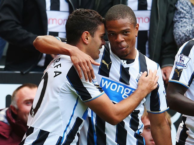 Hatem Ben Arfa of Newcastle United celebrates scoring the opening goal with team mate Loic Remy during the Barclays Premier League match between Newcastle United and Fulham at St James' Park on August 31, 2013