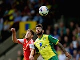 Bradley Johnson of Norwich City battles with Alan Lallana of Southampton during the Barclays Premier League match between Norwich City and Southampton at Carrow Road on August 31, 2013