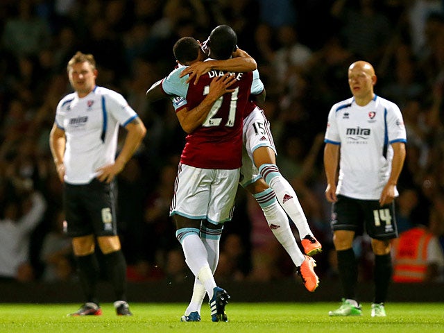 West Ham's Ravel Morrison celebrates with team mate Mohamed Diame after scoring his team's second goal against Cheltenham during their League Cup match on August 27, 2013