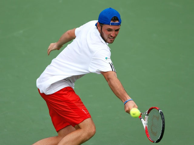 Rhyne Williams returns a backhand to Lleyton Hewit of Australia during the BB&T Atlanta Open in Atlantic Station on July 24, 2013