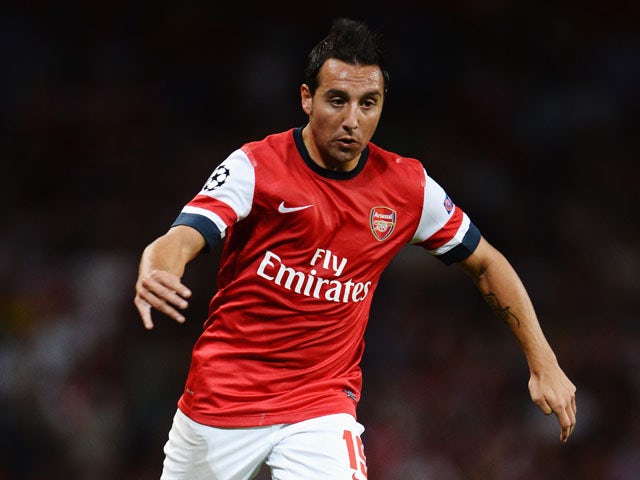 Santi Cazorla of Arsenal runs with the ball during the UEFA Champions League Play Off Second leg match between Arsenal FC and Fenerbahce SK at Emirates Stadium on August 27, 2013