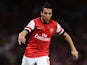 Santi Cazorla of Arsenal runs with the ball during the UEFA Champions League Play Off Second leg match between Arsenal FC and Fenerbahce SK at Emirates Stadium on August 27, 2013