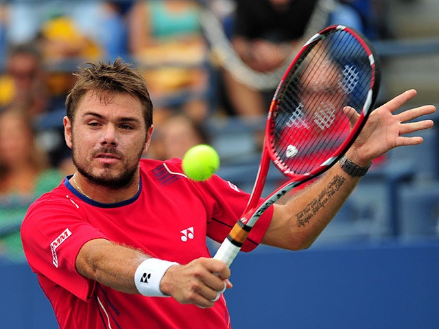 Stanislas Wawrinka in action against Marcos Baghdatis during their US Open third round match on September 1, 2013