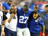 Stevie Brown #27 of the New York Giants is helped off the field after injuring his leg after making an interception against Geno Smith #7 of the New York Jets during their pre season game at MetLife Stadium on August 24, 2013