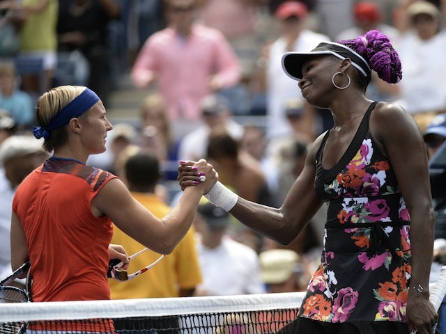 Venus Williams shakes the hand of Kirsten Flipkens following their US Open match on August 26, 2013